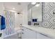 Modern bathroom with geometric tile accent wall, white vanity, and shower/tub combo at 3117 E Campbell Ave, Phoenix, AZ 85016