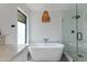 Bright bathroom features a freestanding tub, glass-enclosed shower, and modern fixtures at 3117 E Campbell Ave, Phoenix, AZ 85016