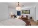 Bright bedroom with a vintage settee, a desk, and hardwood floors at 3117 E Campbell Ave, Phoenix, AZ 85016