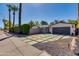Stylish home with a concrete driveway, desert landscaping, and an inviting blue entry gate at 3117 E Campbell Ave, Phoenix, AZ 85016