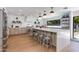 This gorgeous open kitchen features a large island, stainless steel appliances, and wood floors at 3117 E Campbell Ave, Phoenix, AZ 85016
