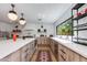 Bright kitchen with white backsplash, modern appliances, sleek countertops, and stylish lighting at 3117 E Campbell Ave, Phoenix, AZ 85016