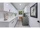 Clean and bright laundry room with modern appliances, plenty of counterspace, and storage at 3117 E Campbell Ave, Phoenix, AZ 85016