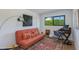 Stylish home office space featuring an orange futon, vintage desk, and contemporary artwork at 3117 E Campbell Ave, Phoenix, AZ 85016