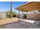 Cozy backyard featuring a covered patio area, desert landscaping, and privacy walls at 3326 E Calypso Ave, Mesa, AZ 85204
