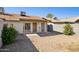 Home featuring a yard with a covered patio, gravel groundcover, and privacy wall at 3326 E Calypso Ave, Mesa, AZ 85204