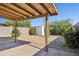 Charming backyard with a covered patio, low-maintenance gravel, and colorful plantings at 3326 E Calypso Ave, Mesa, AZ 85204
