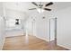Spacious living room with wood floors, ceiling fan, and open access to the kitchen at 3326 E Calypso Ave, Mesa, AZ 85204