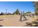 Community playground featuring swings, a slide, and park benches in a sunny setting at 3326 E Calypso Ave, Mesa, AZ 85204