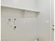 Bright utility room with shelf and connections, located next to a door at 3326 E Calypso Ave, Mesa, AZ 85204