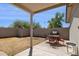 Spacious backyard featuring a covered patio, dining set, grill, and block fence at 3405 S Cutler Dr, Tempe, AZ 85282
