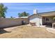 Expansive backyard featuring a covered patio, grill, dining set, and block fence at 3405 S Cutler Dr, Tempe, AZ 85282