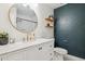 Elegant bathroom features a white vanity, round mirror, and accent wall at 3405 S Cutler Dr, Tempe, AZ 85282