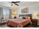 Cozy bedroom featuring a ceiling fan, natural lighting and a built-in desk with ample space at 3405 S Cutler Dr, Tempe, AZ 85282