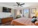 Bright bedroom featuring ceiling fan, hardwood floors, curtains and a dresser for ample storage at 3405 S Cutler Dr, Tempe, AZ 85282