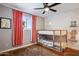 Kid-friendly bedroom featuring bunk beds with window view, ceiling fan, and bright-colored decor at 3405 S Cutler Dr, Tempe, AZ 85282
