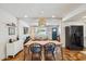 Bright dining area with modern light fixture, dining table set, and an open view to the living spaces at 3405 S Cutler Dr, Tempe, AZ 85282