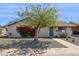 Welcoming single-story home with desert landscape, well-manicured yard, and a charming front porch at 3405 S Cutler Dr, Tempe, AZ 85282