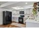 Modern kitchen features white cabinets, black appliances, stainless steel sink and bright skylight at 3405 S Cutler Dr, Tempe, AZ 85282