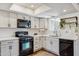 Bright kitchen featuring white cabinets, quartz countertops, and stainless steel appliances at 3405 S Cutler Dr, Tempe, AZ 85282