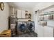 Well-equipped laundry room boasts modern stainless steel washer and dryer, tiled floor, and ample storage space at 3405 S Cutler Dr, Tempe, AZ 85282