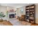 Cozy living room showcasing a brick fireplace, built-in bookshelf, and comfortable seating at 3405 S Cutler Dr, Tempe, AZ 85282