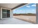 Covered back patio with a large sliding glass door provides a view of the spacious, undeveloped backyard at 3974 E Ghost Flower Ln, San Tan Valley, AZ 85140