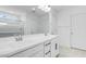 Modern bathroom featuring double sinks, white cabinets, and a large mirror and a glass enclosed shower at 3974 E Ghost Flower Ln, San Tan Valley, AZ 85140