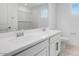 Bright bathroom featuring double sinks, white cabinets, and a large mirror at 3974 E Ghost Flower Ln, San Tan Valley, AZ 85140