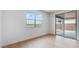 Bright bedroom with hardwood floors, large windows and sliding glass door to patio at 3974 E Ghost Flower Ln, San Tan Valley, AZ 85140