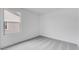 Bright bedroom featuring neutral carpet, bright white walls, and a large window at 3974 E Ghost Flower Ln, San Tan Valley, AZ 85140