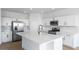 Bright kitchen featuring white cabinets, stainless steel appliances, a large island, and updated fixtures at 3974 E Ghost Flower Ln, San Tan Valley, AZ 85140