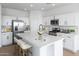 Beautiful kitchen with white cabinetry, stainless steel appliances, a large island, and modern finishes at 3974 E Ghost Flower Ln, San Tan Valley, AZ 85140