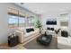 Bright living room with comfortable seating, neutral decor, large windows, and plenty of natural light at 3974 E Ghost Flower Ln, San Tan Valley, AZ 85140