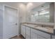 Modern bathroom features double vanity, a large mirror, and shower at 39970 W Bravo Dr, Maricopa, AZ 85138