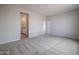 Bright, carpeted bedroom with doorway to the en-suite bathroom at 39970 W Bravo Dr, Maricopa, AZ 85138