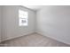 Cozy bedroom with a carpeted floor, natural light from the window, and fresh neutral paint at 39970 W Bravo Dr, Maricopa, AZ 85138