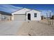 Charming single-story home featuring a neutral color palette, desert landscaping, and a quaint, covered front entrance at 39970 W Bravo Dr, Maricopa, AZ 85138