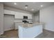 Modern kitchen features stainless appliances, granite countertops, kitchen island, and recessed lighting at 39970 W Bravo Dr, Maricopa, AZ 85138