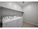 Laundry room with Whirlpool washer and dryer and shelving at 39970 W Bravo Dr, Maricopa, AZ 85138