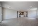Large living area featuring open kitchen and tile flooring, perfect for entertaining at 39970 W Bravo Dr, Maricopa, AZ 85138