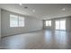 Spacious, naturally lit living area featuring tile flooring and a sliding glass door at 39970 W Bravo Dr, Maricopa, AZ 85138