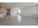 Expansive living area with tile flooring, recessed lighting, and neutral walls, offering flexible design options at 39970 W Bravo Dr, Maricopa, AZ 85138