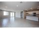 Spacious living area featuring open kitchen and tile flooring, creating a great room concept at 39970 W Bravo Dr, Maricopa, AZ 85138