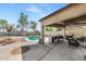 Backyard featuring pool, BBQ island, covered patio, and landscaped area at 4115 S 75Th Dr, Phoenix, AZ 85043