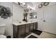 Dual sink bathroom vanity, decorative mirror accents, and neutral tile flooring at 4115 S 75Th Dr, Phoenix, AZ 85043