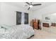 Cozy bedroom with neutral colors, ceiling fan, and mirrored closet doors at 4115 S 75Th Dr, Phoenix, AZ 85043