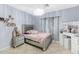 Stylish bedroom with a silver bed frame, vanity with Hollywood lights, and decorative shelves at 4115 S 75Th Dr, Phoenix, AZ 85043