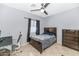 Comfortable bedroom with neutral wall paint, bedside table, and tiled floor at 4115 S 75Th Dr, Phoenix, AZ 85043