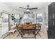 Bright breakfast nook with a modern table set, ceiling fan, and multiple windows overlooking the pool area at 4115 S 75Th Dr, Phoenix, AZ 85043